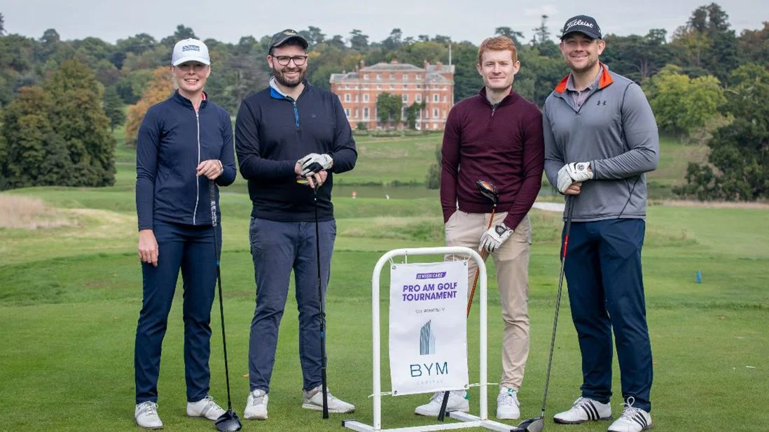 Four golfers on a golf course